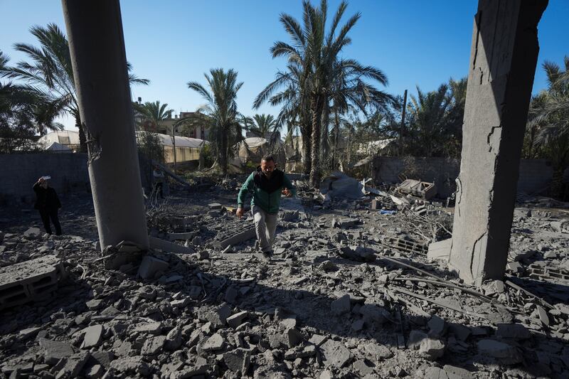 A Palestinian inspects the rubble of a destroyed building following an overnight Israeli strike in Deir al-Balah, Gaza Strip (Abdel Kareem Hana/AP)