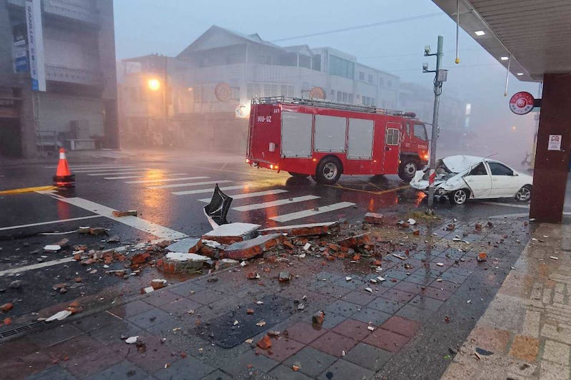 A car is hit by falling walls in Hualien county, Taiwan (Hualien Fire Department/AP)