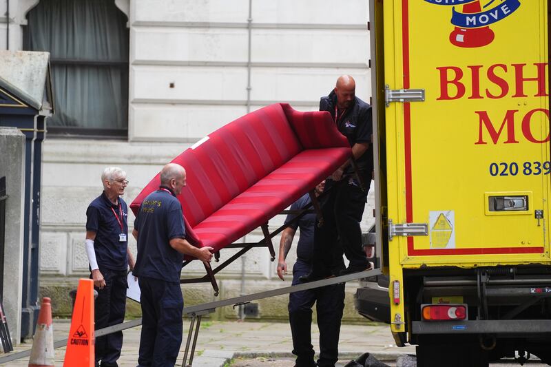 A sofa being loaded into the removal van at the back of Downing Street