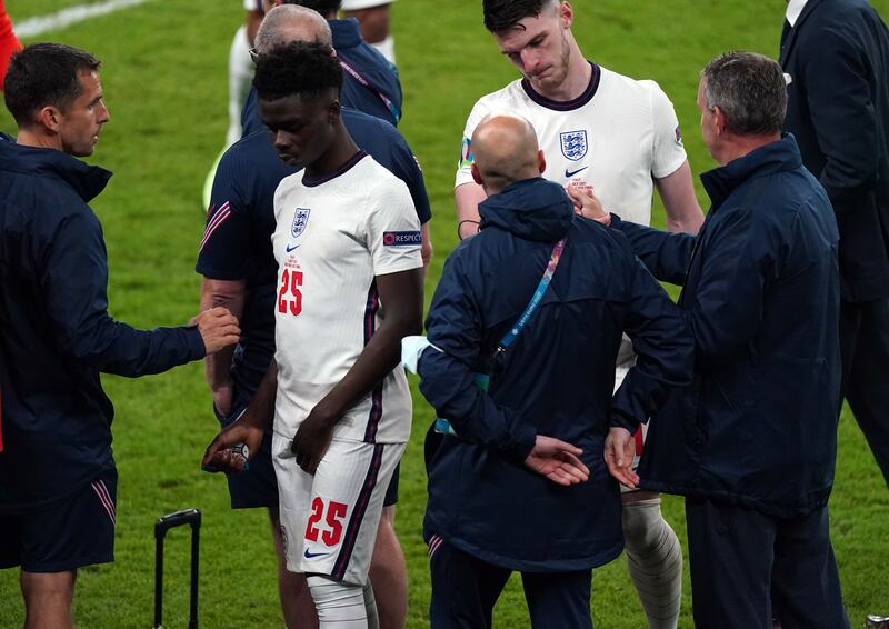 Bukayo Saka (second left) was one of three England players racially abused after missing a penalty in the European Championships final in 2021