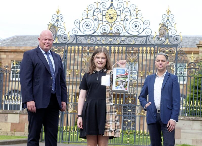 King of Paints founder Peter Hamill (left) and his daughter Lauren, outside the the gates of Hillborough Castle with the company&#39;s vice president, Marc Sant Angelo. Picture by Mal McCann. 