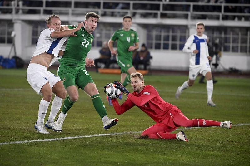 Nathan Collins shields blocks Finland striker Joel Pohjanpalo as Ireland goalkeeper Caoimhin Kelleher grabs the ball (Antti Aimo-Koivisto/Lehtikuva via AP)