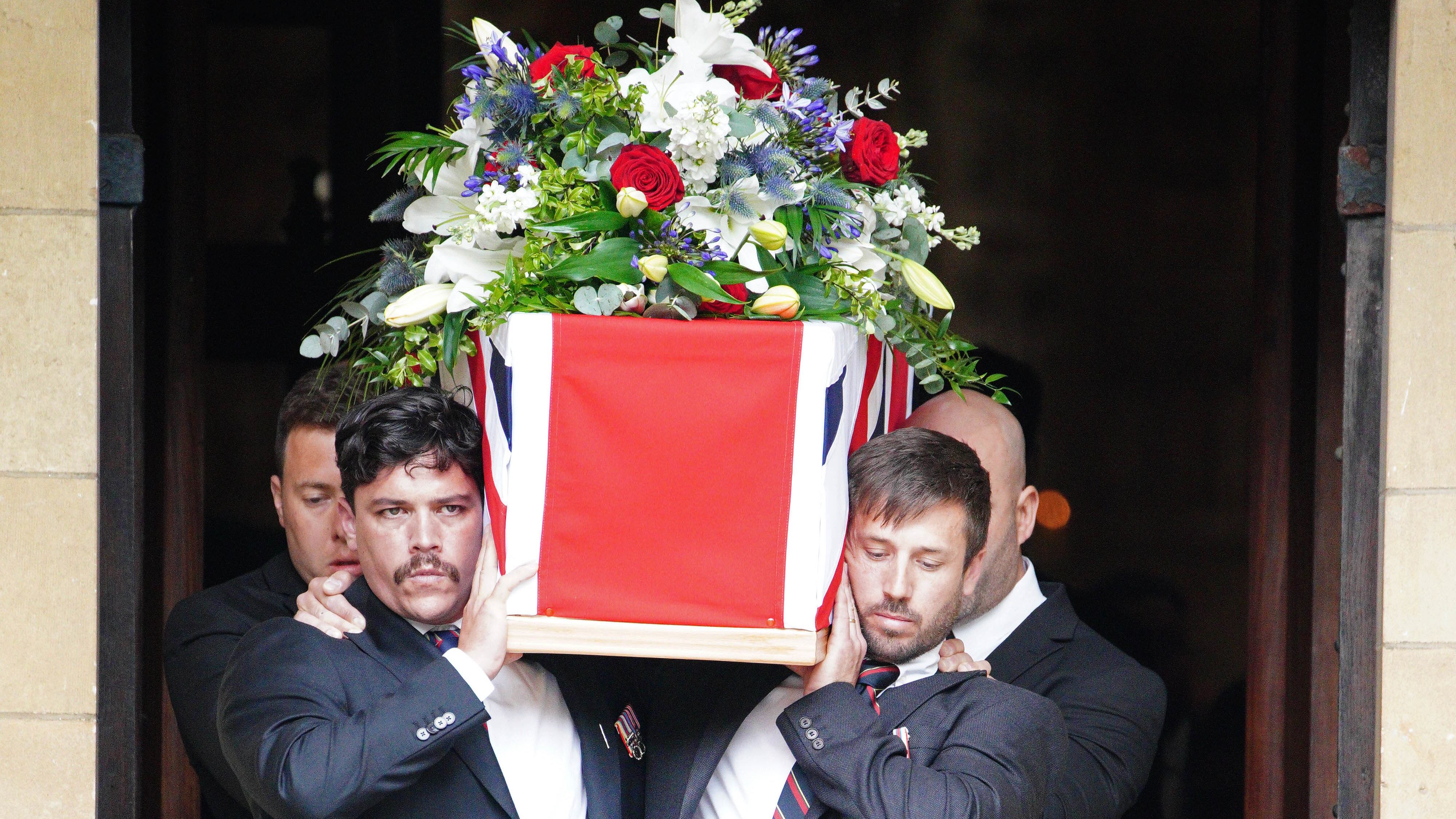 Former colleagues of Mr Henderson carry his coffin