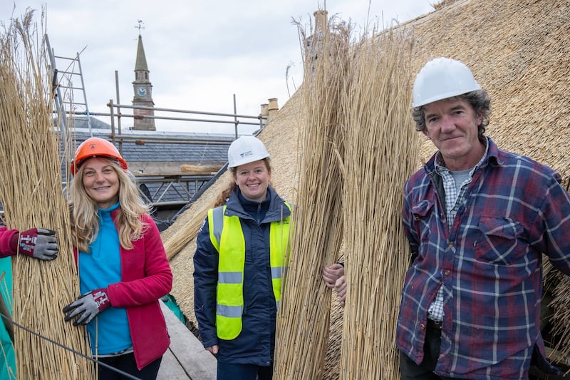 Restoration of Bachelors Cottage – thatcher Jane Benwell and Laura-Baillie, NTS building conservation surveyor with Jonathan Botterell .