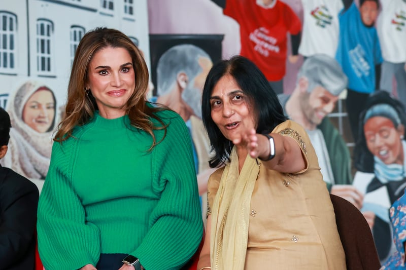 Queen Rania of Jordan (left) listening to founder and CEO of ArtsEkta Dr Nisha Tandon during her visit to the Conway Education Centre at Conway Mill in Belfast, during her visit to the One Young World Summit