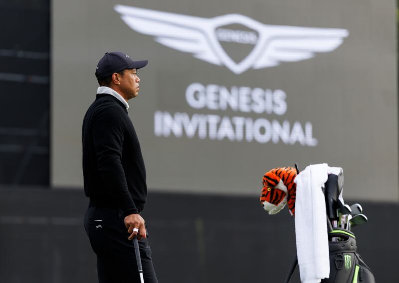 Tiger Woods looks on as he warms up on the practice range prior to the Genesis Invitational pro-am (Ryan Kang/AP)