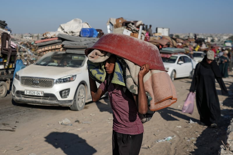 A Palestinian youth flees the Khan Younis area of the Gaza Strip following Israeli military evacuation orders (Abdel Kareem Hana/AP)