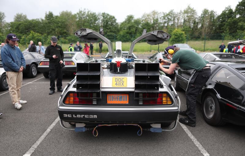 DeLorean owners gather at the Cutts in Dunmurry on Sunday as they drive on the old test track as part of the DeLorean Revival in Belfast.
PICTURE COLM LENAGHAN