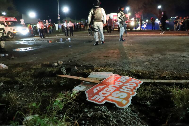 Electoral signs lay on the ground as security forces secured the area after the collapse (Alberto Lopez/AP)