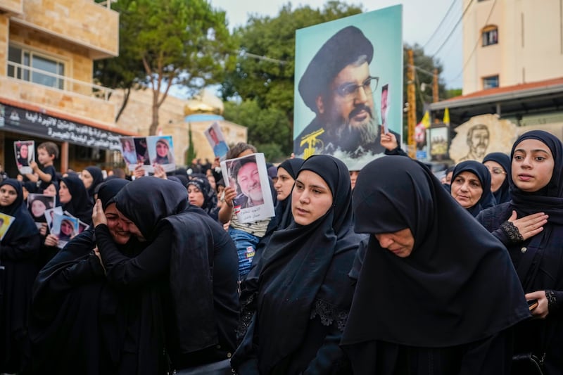 Mourners carry a picture of Hezbollah leader Hassan Nasrallah (Hassan Ammar/AP)