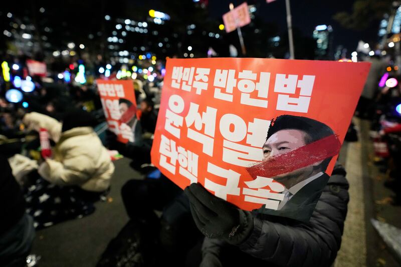 Participants hold banners during a rally to demand South Korean President Yoon Suk Yeol’s impeachment (Ahn Young-Joon/AP)