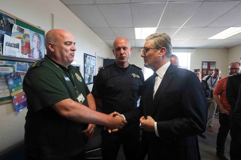 Prime Minister Sir Keir Starmer (right) meets with emergency personnel during a visit to Southport