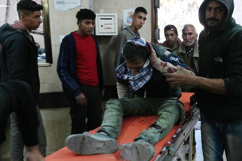 A Palestinian man injured in an Israeli air strike arrives at hospital in the Gaza Strip (Adel Hana/AP)