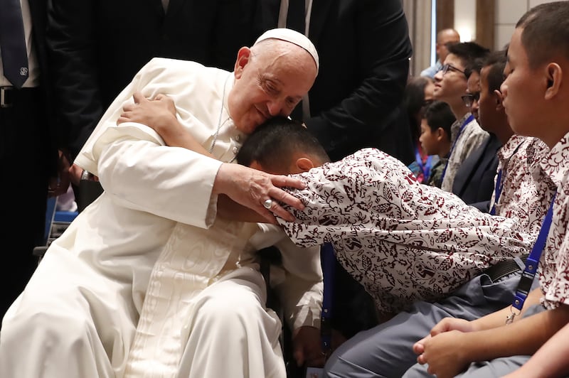 Pope Francis blesses a beneficiary from charitable organisations at the Indonesian Bishops’ Conference Headquarters in Jakarta (Adi Weda/AP)