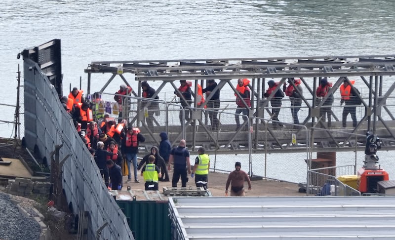 A group of people believed to be migrants are taken to Dover from a Border Patrol ship