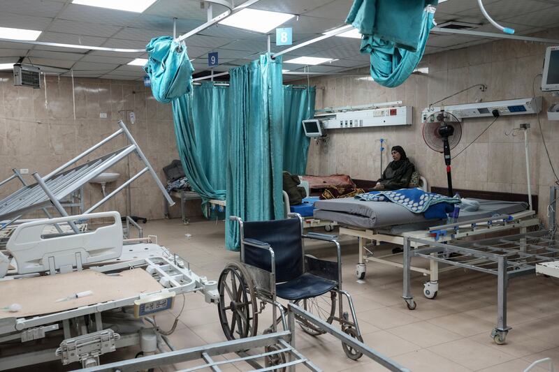 A woman sits on a bed in a room of the Al-Aqsa Martyrs hospital in Deir al Balah (Abdel Kareem Hana/AP)