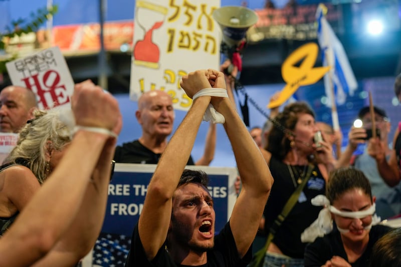 A demonstrator with his hands tied calls for a ceasefire deal and immediate release of hostages held in Gaza during a protest in Tel Aviv, Israel (Ariel Schalit/AP)