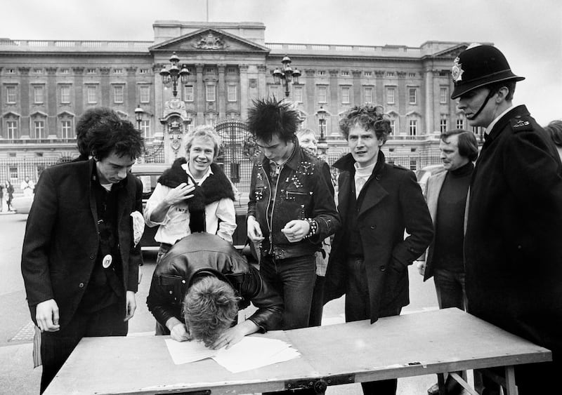 The Sex Pistols with Malcolm McLaren signing a recording contract outside Buckingham Palace in their early days