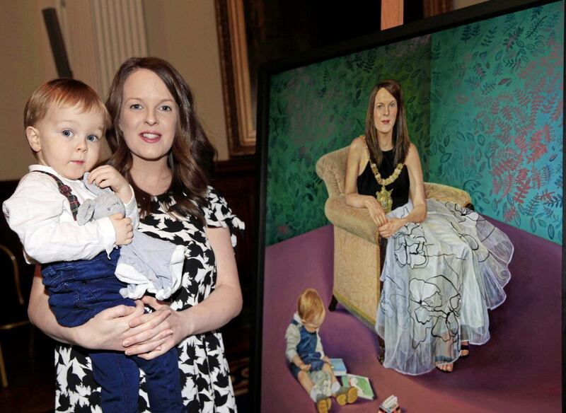 Former Lord Mayor Nuala McAlister with her son Finn at the unveiling of her official portrait painted by Jamie Baird and Daniel Nelis. PICTURE: PHILIP WALSH 