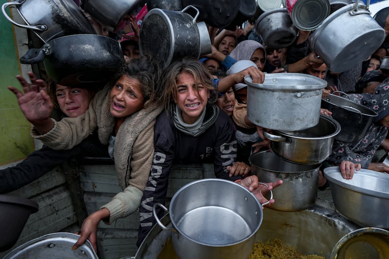 Palestinian women and girls struggle to reach for food in Gaza (Abdel Kareem Hana/AP)