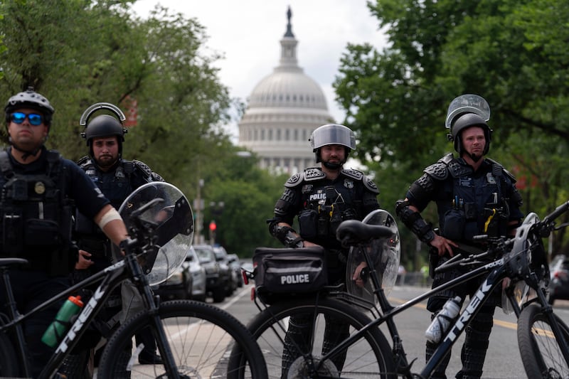 US Capitol police watch demonstrators marching outside of the US Capitol as they protest the visit of Israeli Prime Minister Benjamin Netanyahu on Capitol Hill (Jose Luis Magana/AP)