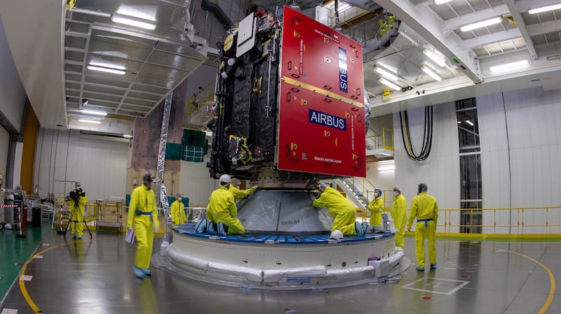 Juice being slowly lifted into the air then carefully lowered onto the top of the Ariane 5 rocket