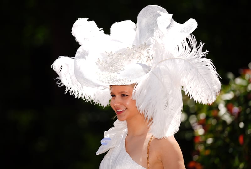 Another racegoer dons an extravagant diamante white feathered hat