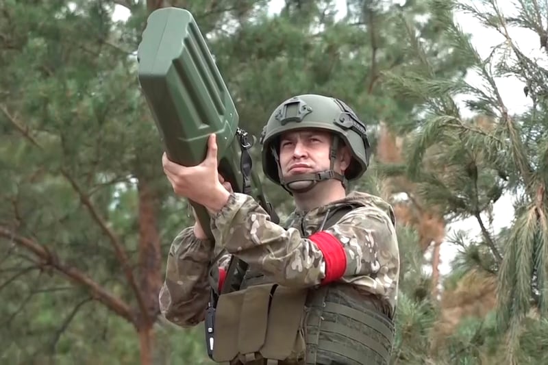 A Russian serviceman aims an anti-drone gun in an undisclosed location (Russian Defense Ministry Press Service via AP)