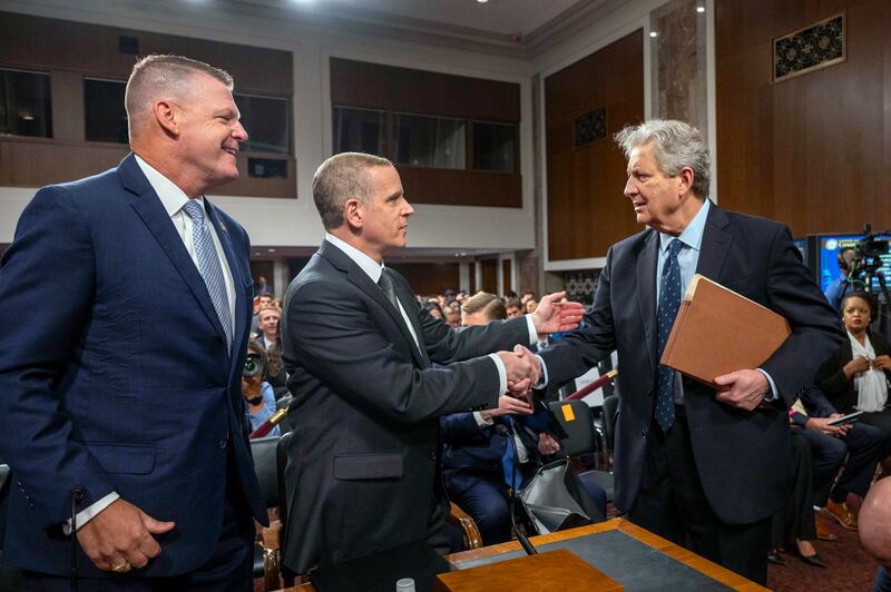 Senator John Kennedy meets with FBI deputy director Paul Abbate and US Secret Service acting director Ronald Rowe before they give evidence to the hearing (AP)