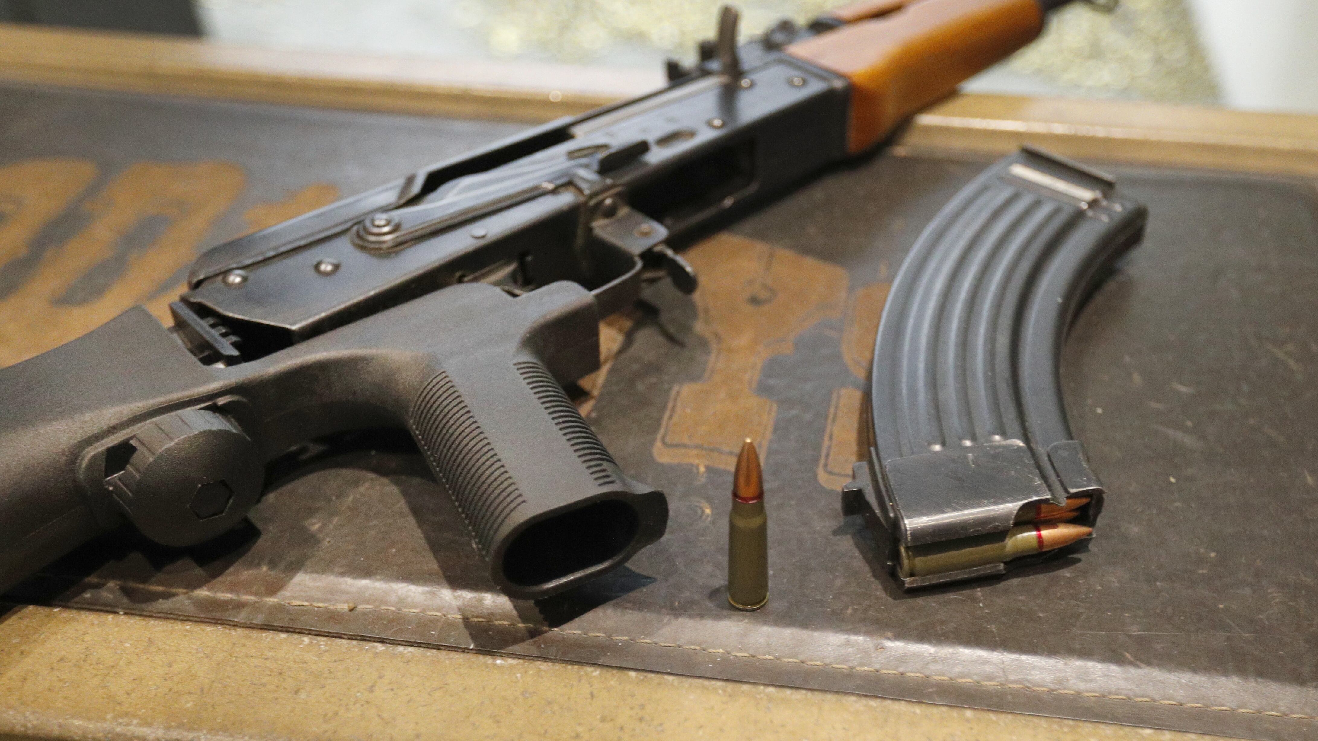 A 30-round magazine sits next to an AK-47 fitted with a bump stock, a device which allows a semi-automatic gun to fire at a rapid rate much like a fully automatic gun