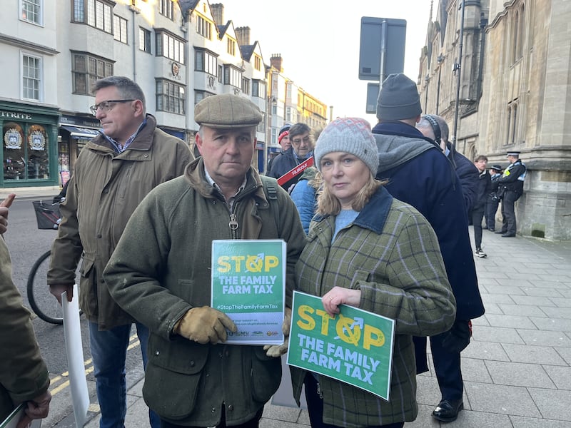 Heidi and Jonathan Smith, farmers from Oxfordshire, take part in a protest over the changes to inheritance tax rules outside the Oxford Farming Conference