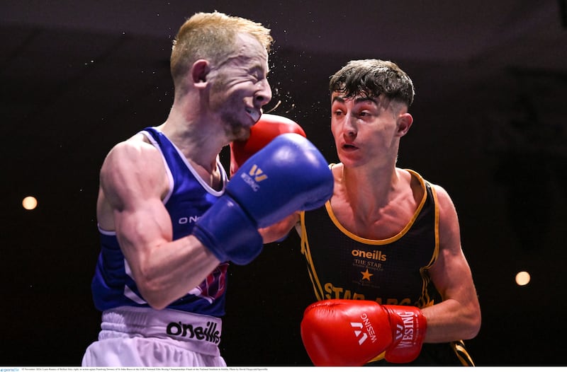 Star's Louis Rooney lands an eye-catching shot on Padraig Downey of St John Bosco in Friday night's light-fly final of the Irish Elote Championships. Photo by David Fitzgerald/Sportsfile