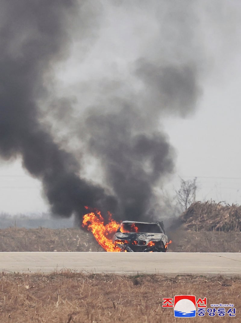 A burning vehicle during tests of drones designed to crash into targets, at an undisclosed location in North Korea (Korean Central News Agency/Korea News Service via AP)