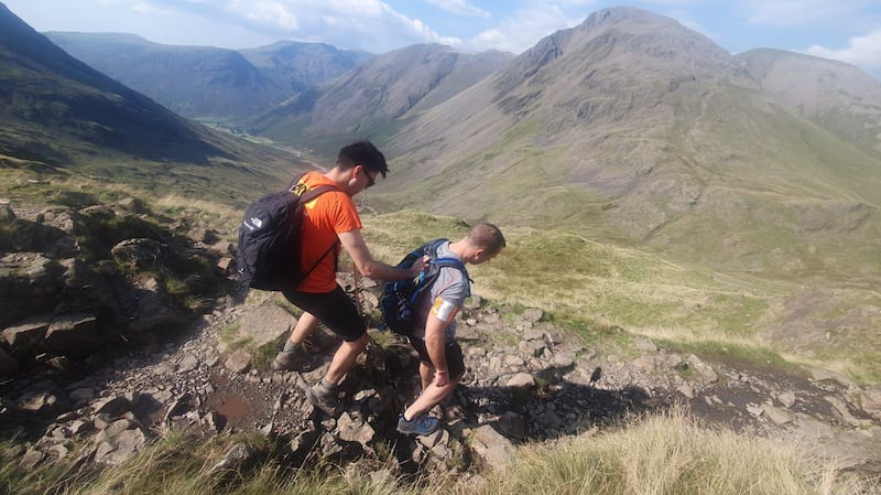 Michael Smith (left) had to hold onto Jack Stacy’s (right) rucksack, shoulder or arm to help guide him through difficult terrain (SeeAbility)