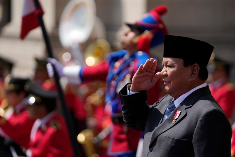 Indonesian President Prabowo Subianto salutes the honour guard during a welcoming ceremony at the government palace in Lima, Peru (AP Photo/Fernando Vergara)