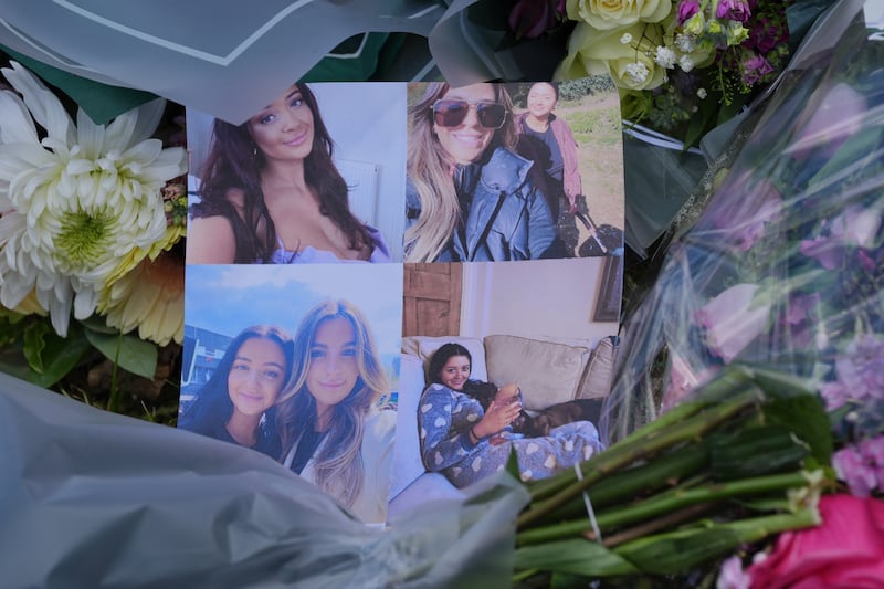 Pictures left on floral tributes at the scene of the killings