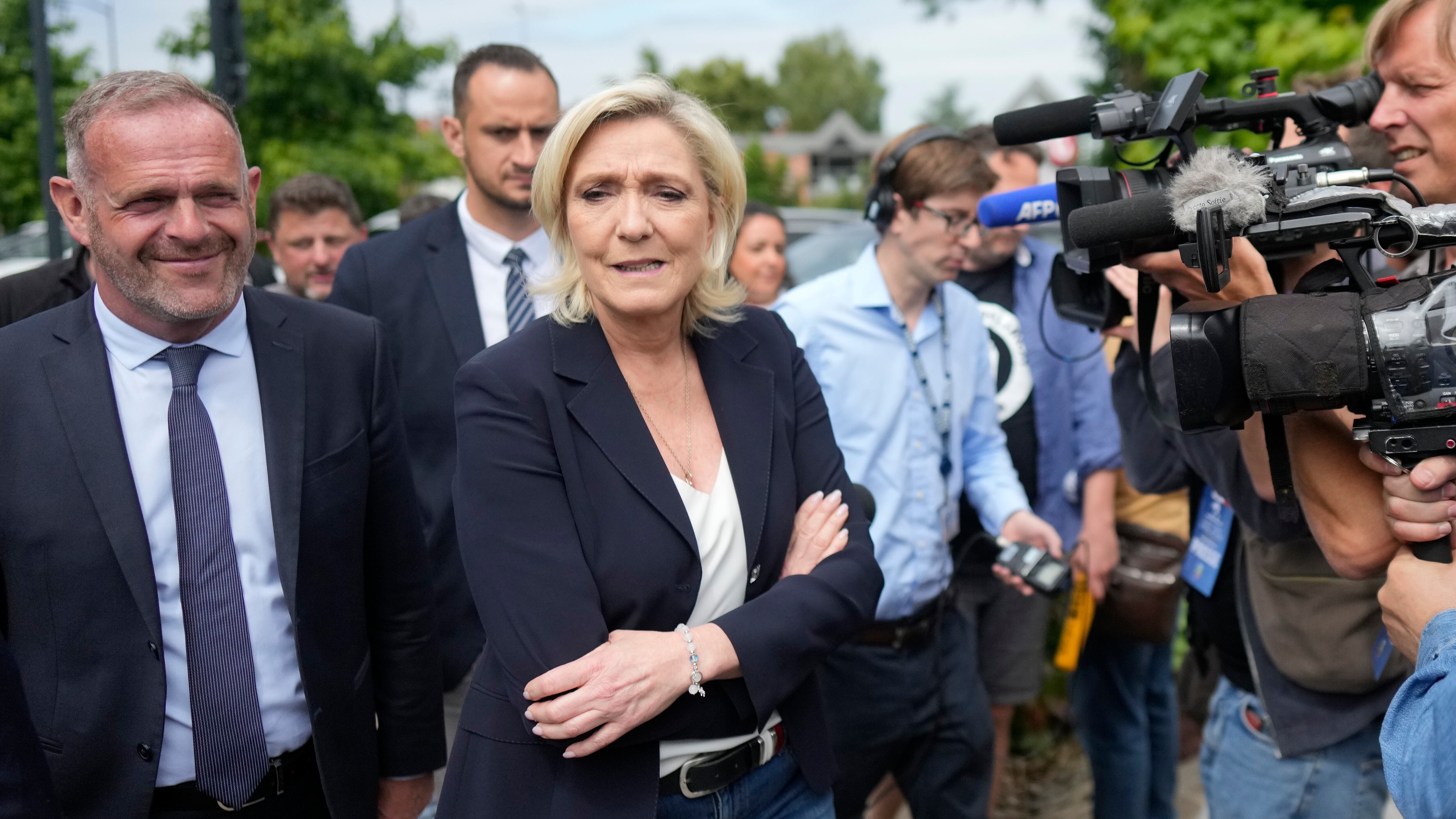 French far right leader Marine Le Pen, centre, with local mayor Steeve Briois, after voting in the first round of the parliamentary election (AP Photo/Thibault Camus)