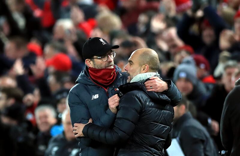 Jurgen Klopp (left) and Manchester City counterpart Pep Guardiola hug after the final whistle
