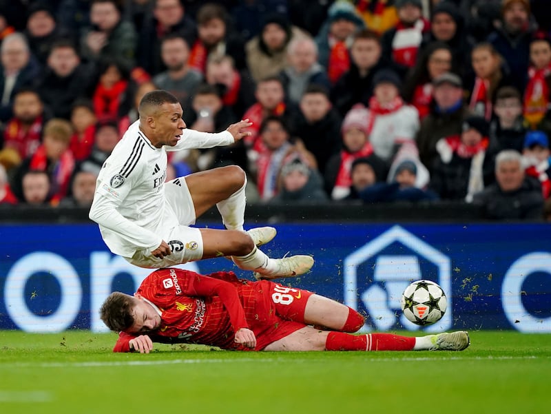 Liverpool's Conor Bradley (bottom) tackles Real Madrid's Kylian Mbappe during the UEFA Champions League, league stage match at Anfield, Liverpool. Picture date: Wednesday November 27, 2024. PA Photo. See PA story SOCCER Liverpool. Photo credit should read: Peter Byrne/PA Wire.

RESTRICTIONS: Use subject to restrictions. Editorial use only, no commercial use without prior consent from rights holder.