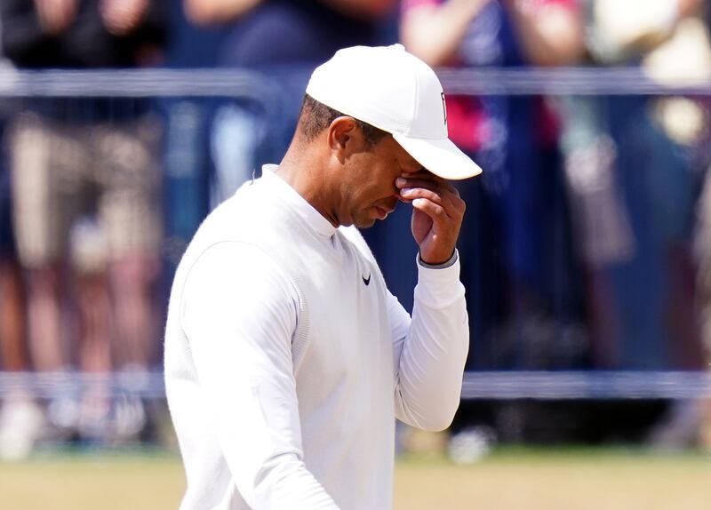 Tiger Woods wipes his eyes on his way down the 18th hole during day two of the 2022 Open at the Old Course, St Andrews