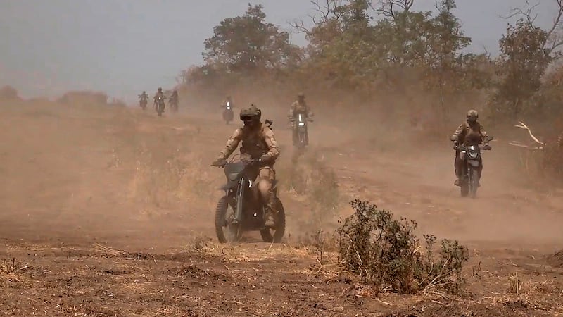 Marine assault team members ride motorcycles towards a Ukrainian position at an undisclosed location