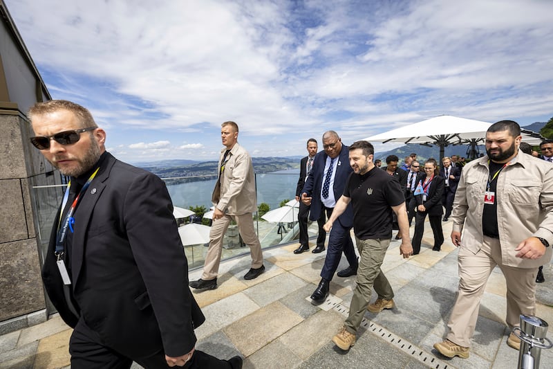 Ukrainian President Volodymyr Zelensky, centre, and Fiji’s President Wiliame Maivalili Katonivere walk during the Summit on peace in Ukraine, in Obburgen, Switzerland (Michael Buholzer/AP)