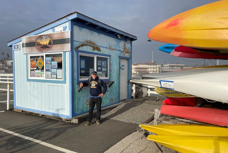 David Johnston, owner of wharf based Venture Quest kayaking, stands by his shop on the Santa Cruz wharf (Martha Mendoza/AP)