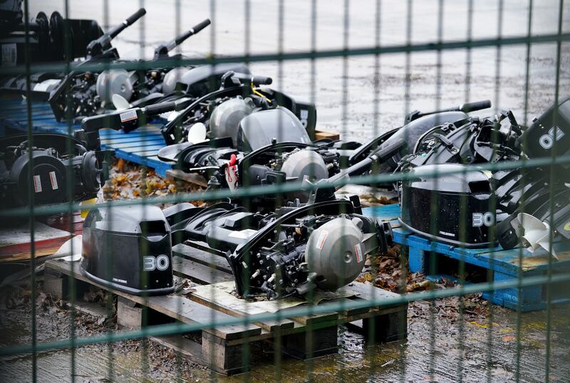 A view of small boat engines used to cross the Channel by people thought to be migrants at a warehouse facility in Dover, Kent