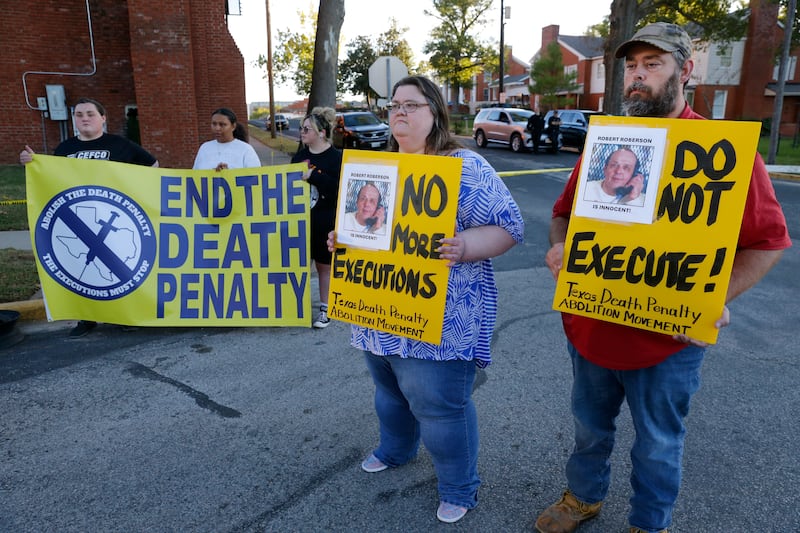 Campaigners including Thomas Roberson, right, older brother of Robert Roberson, protest outside the prison where Roberson was scheduled for execution in Huntsville, Texas (Michael Wyke/AP)