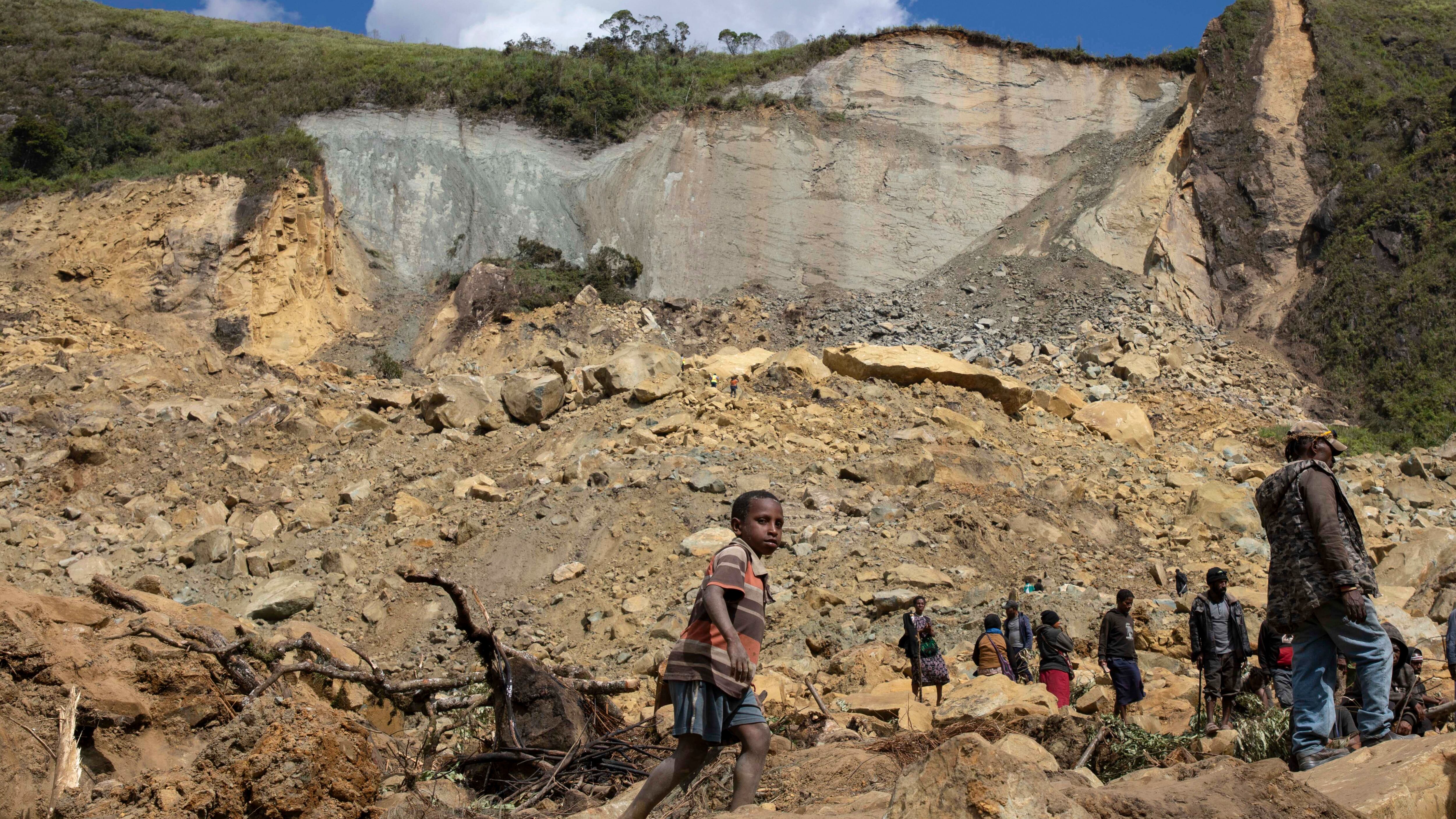 Villagers search through a landslide in Yambali in Papua New Guinea (Juho Valta/UNDP Papua New Guinea via AP)