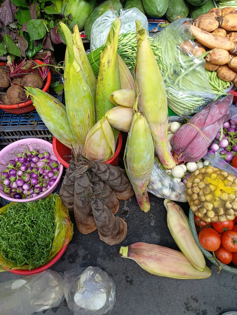 Green banana flower (centre), lotus (top right), small eggplants (left)