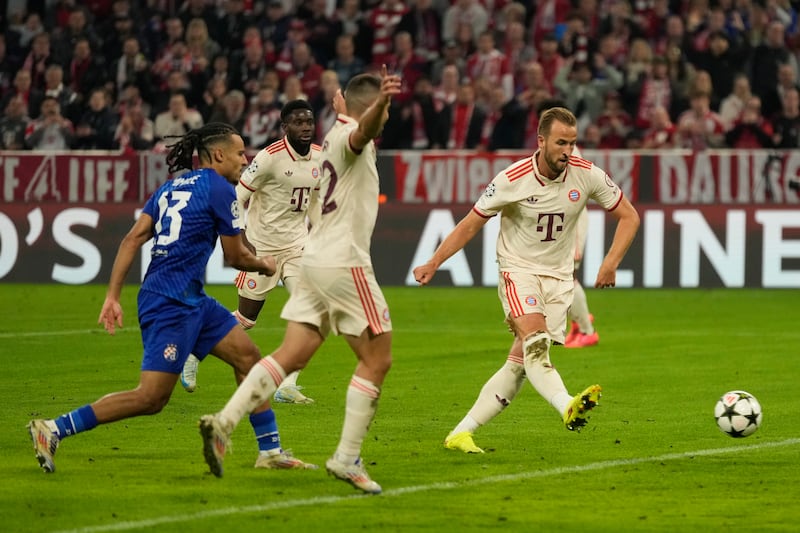 Harry Kane, right, scores his second goal against Dinamo Zagreb to become the leading English goalscorer in the Champions League (Matthias Schrader/AP)