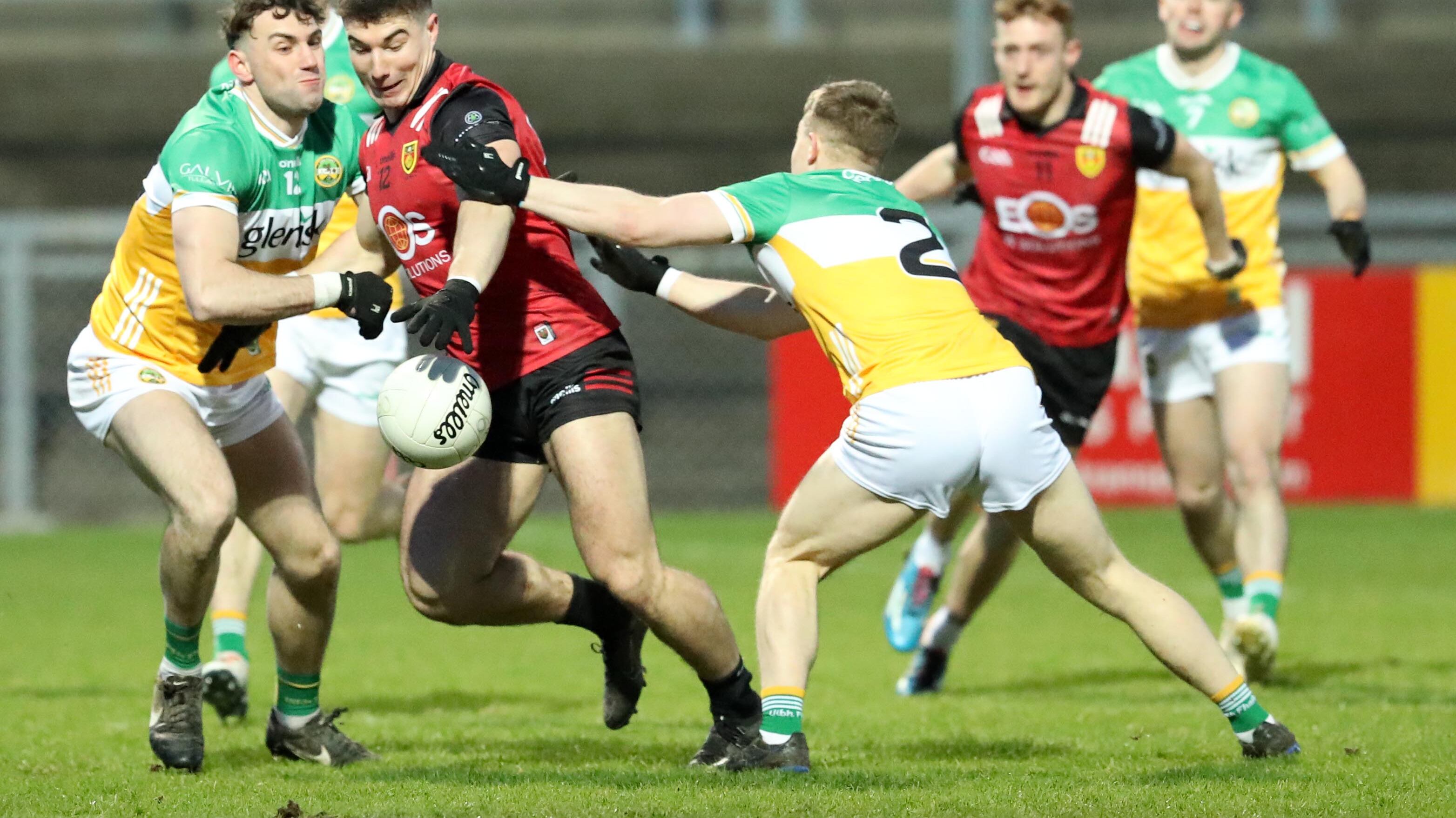 Down's Daniel Guinness and Offaly's Lee Pearson and Jordan Hayes in action during the GAA Allianz Football  Division Three Round Four game between Down and Offaly  at Páirc Esler, Newry 0n 02-24-2024