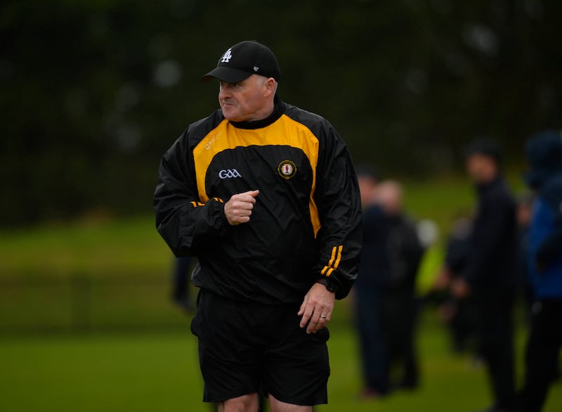 A man wearing a black and amber windbreaker and an LA black cap